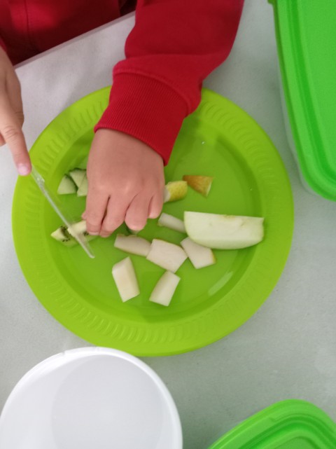 Child cutting fruit